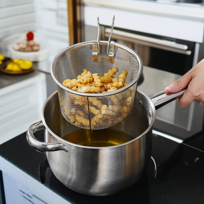 Home fryer with removable strainer for easy oil drainage